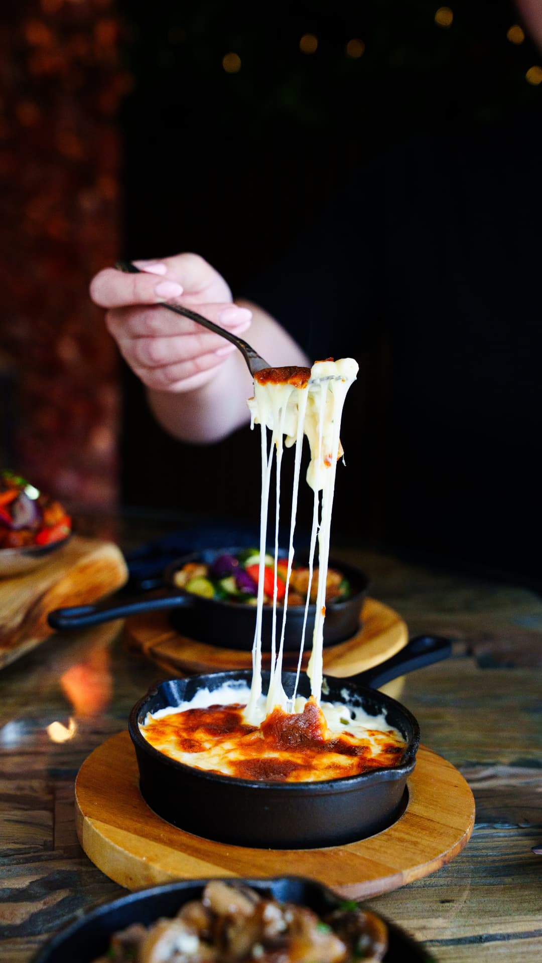 Baked cheese dish with a dramatic melted cheese pull